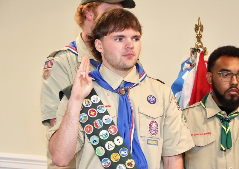James Falk Jr. gives the scout salute during the Court of Honor. He said confidence and kindness were two of the most important things he learned on his journey to Eagle Scout.